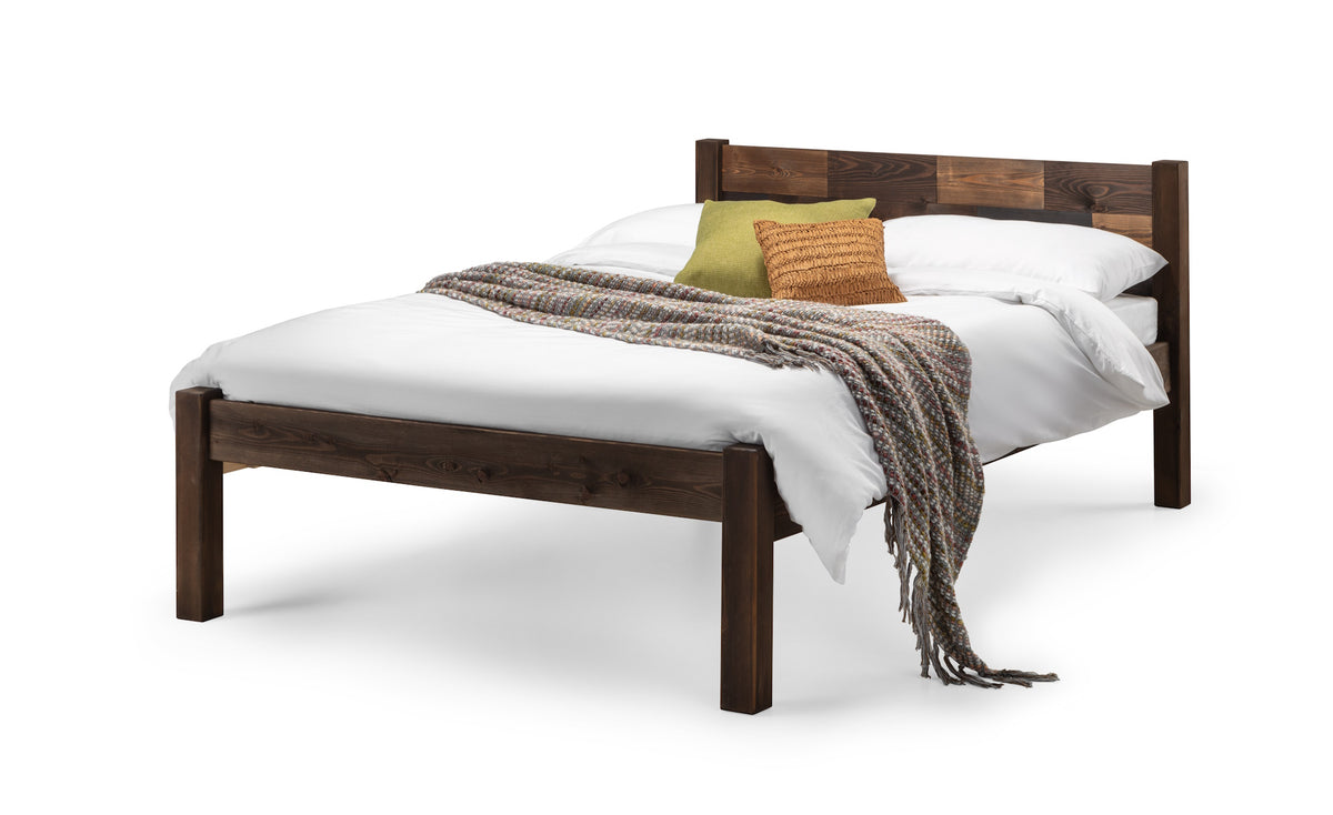 Wooden bed with white bedding 